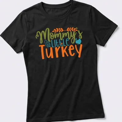 Playful script saying Mommy's Little Turkey above a cheerful cartoon turkey — printed on a women's shirt