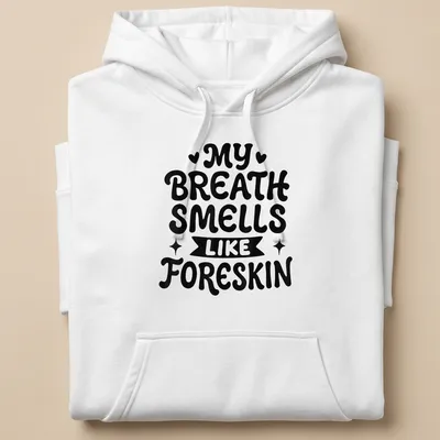 Bold humorous text saying My Breath Smells Like Foreskin in black and white — printed on a unisex hoodie