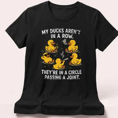 Cartoon ducks in a circle with humorous text about passing a joint — printed on a women's shirt