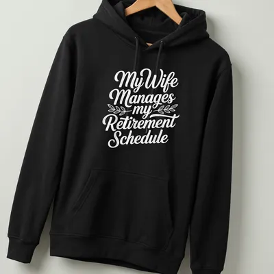 Funny t-shirt with script typography reading 'My Wife Manages my Retirement Schedule' — printed on a unisex hoodie