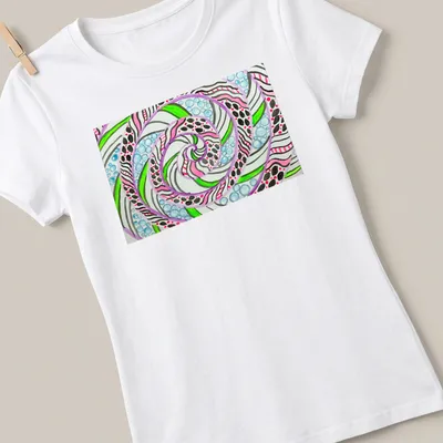 Colorful abstract swirl mandala featuring neon pink, green, blue, and white designs on black — printed on a women's shirt