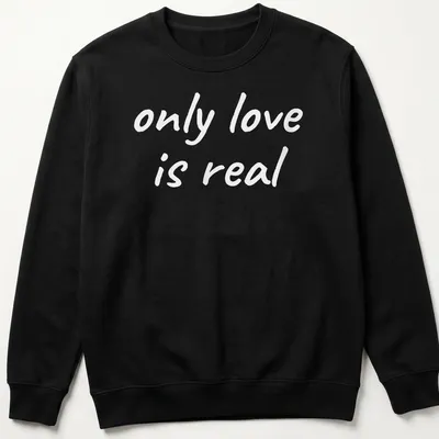 Elegant typography of 'only love is real' on a spiritual — printed on a unisex sweatshirt