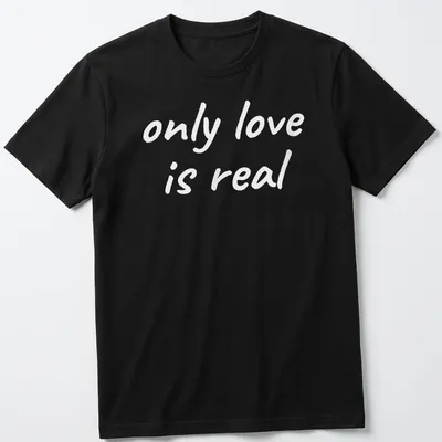 Elegant typography of 'only love is real' on a spiritual T-shirt