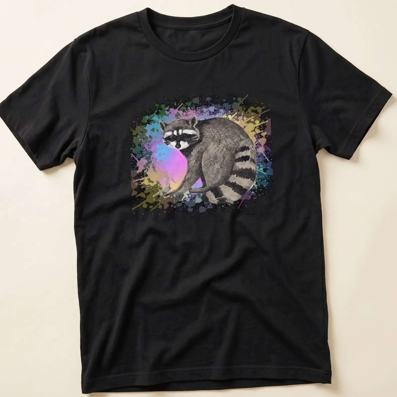 Watercolor print of a raccoon surrounded by colorful background in various hues — printed on a unisex t-shirt