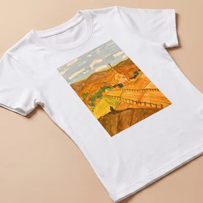 Impressionistic print of a scenic rural landscape with a church and mountains — printed on a women's shirt