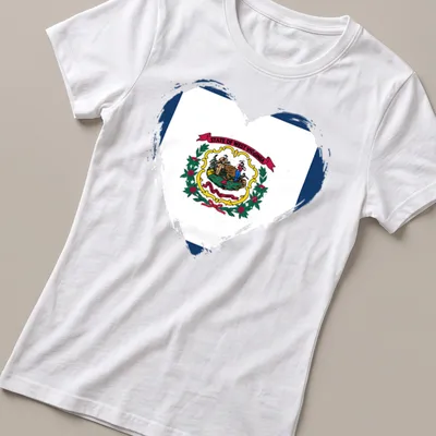 Distressed heart design featuring the West Virginia state flag colors and text. — printed on a women's shirt