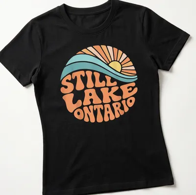 Retro wave design featuring a sunrise over Lake Ontario with vibrant colors — printed on a women's shirt