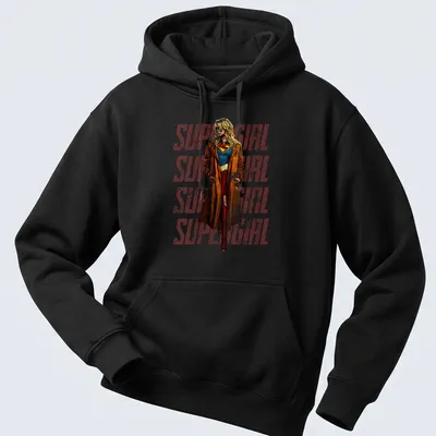 Vintage Supergirl design featuring repeated text in red, blue, brown, and yellow — printed on a unisex hoodie