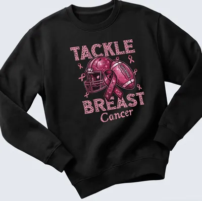Colorful T-shirt featuring a football helmet and ball with a pink ribbon and awareness message — printed on a unisex sweatshirt