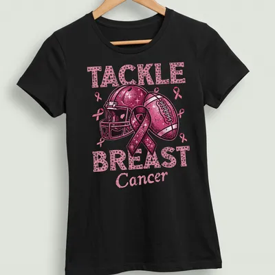 Colorful T-shirt featuring a football helmet and ball with a pink ribbon and awareness message — printed on a women's shirt