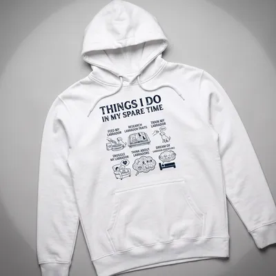 Illustrative t-shirt featuring a Labrador Retriever and humorous text about Labrador activities — printed on a unisex hoodie