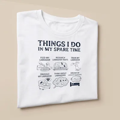 Illustrative t-shirt featuring a Labrador Retriever and humorous text about Labrador activities — printed on a unisex t-shirt (angled view)