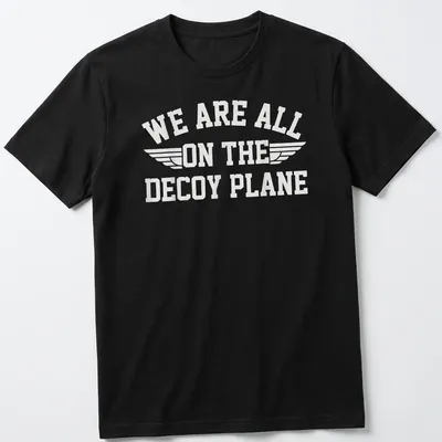 Bold typography t-shirt with the phrase 'We Are All On The Decoy Plane' and wings design in white — printed on a unisex t-shirt