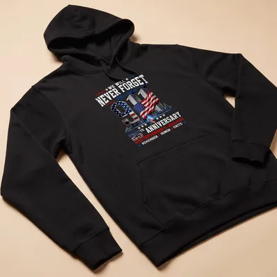 Patriotic graphic T-shirt featuring 9/11 memorial and American flag colors — printed on a unisex hoodie