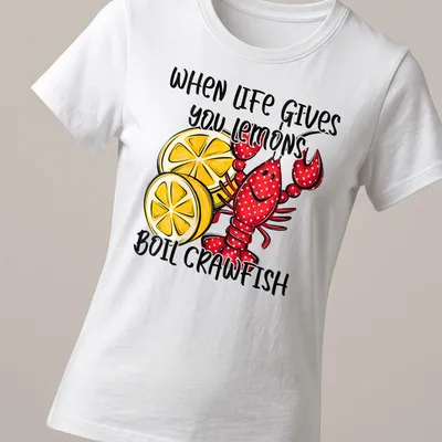 Playful cartoon shirt featuring red crawfish and lemons with humorous text — printed on a women's shirt