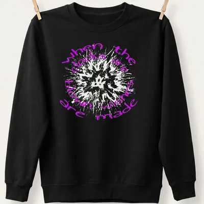 Text art shirt featuring dandelions and the phrase when the clocks are blown wishes made in purple and white — printed on a unisex sweatshirt