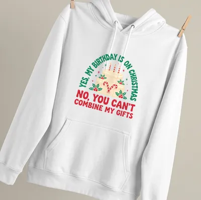 A festive T-shirt featuring a birthday cake with candles and candy canes alongside humorous text. — printed on a unisex hoodie