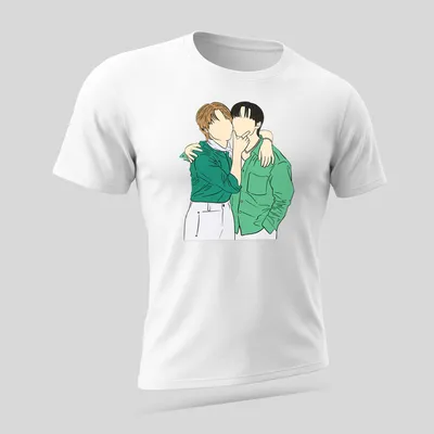 Line-art design of two characters embracing in green, white, black, and brown — printed on a unisex t-shirt (angled view)